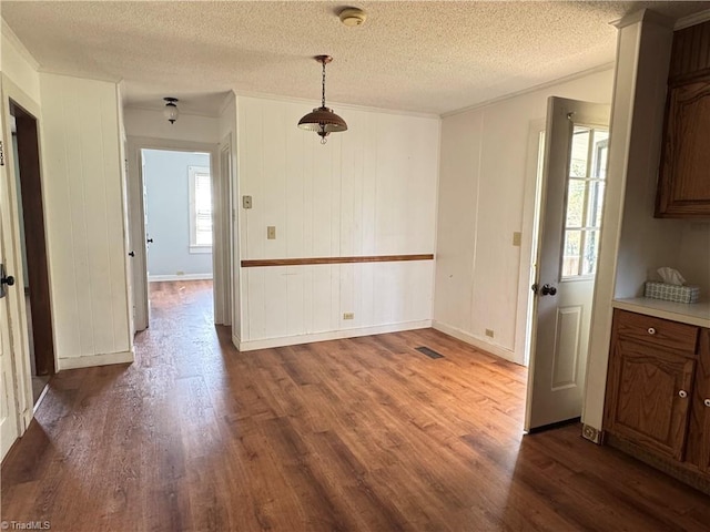 2121/2117 Swan Creek Rd, Jonesville, NC 28642 - unfurnished dining area featuring dark wood-type flooring, a textured ceiling, and ornamental molding