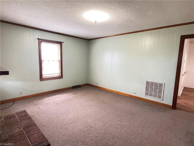 2121/2117 Swan Creek Rd, Jonesville, NC 28642 - empty room with crown molding, visible vents, carpet, and a textured ceiling