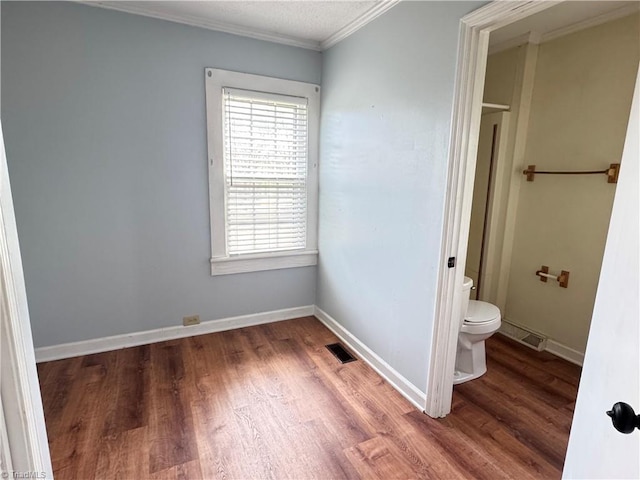 2121/2117 Swan Creek Rd, Jonesville, NC 28642 - bathroom with baseboards, ornamental molding, toilet, visible vents, and wood finished floors