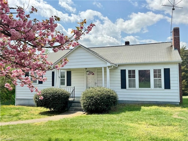 2121/2117 Swan Creek Rd, Jonesville, NC 28642 - view of front facade featuring a porch, a front lawn, and a chimney