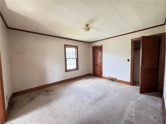 2121/2117 Swan Creek Rd, Jonesville, NC 28642 - unfurnished bedroom featuring carpet, a closet, ornamental molding, visible vents, and baseboards