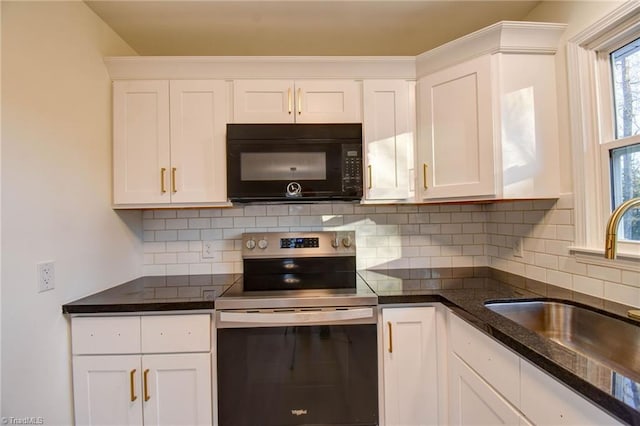 kitchen with sink, tasteful backsplash, dark stone countertops, electric stove, and white cabinets