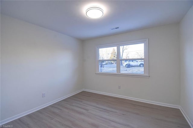 spare room with light hardwood / wood-style floors