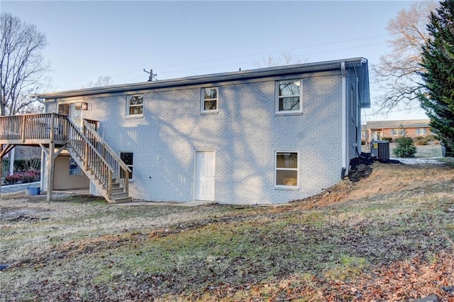 back of house with a wooden deck and central AC unit