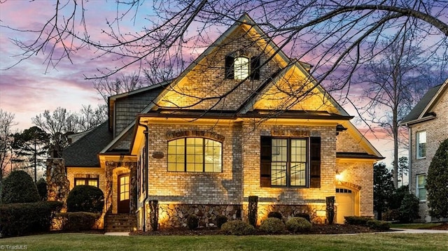 view of front of home with a garage and a yard