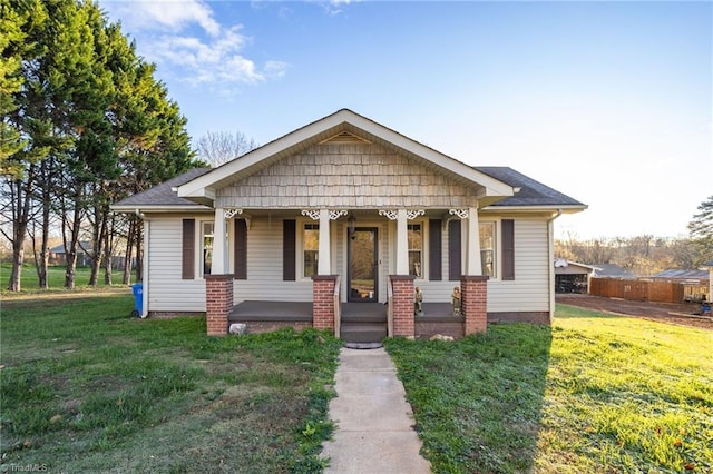 bungalow with a front yard and a porch