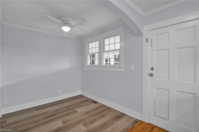 entryway featuring crown molding, ceiling fan, and wood-type flooring