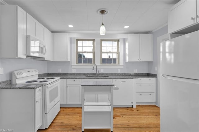 kitchen with white appliances, sink, pendant lighting, light hardwood / wood-style flooring, and white cabinetry