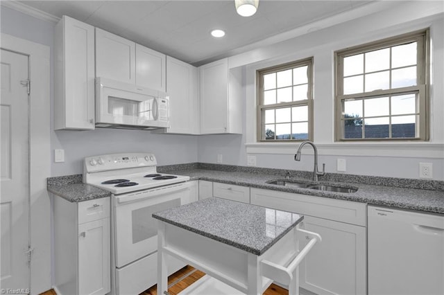 kitchen with white cabinets, white appliances, and sink