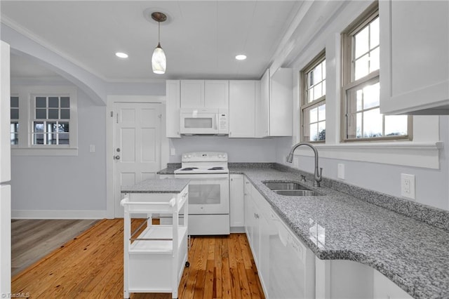 kitchen with sink, white cabinets, white appliances, and light wood-type flooring