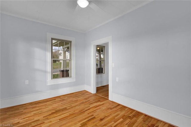 empty room with hardwood / wood-style floors and ornamental molding