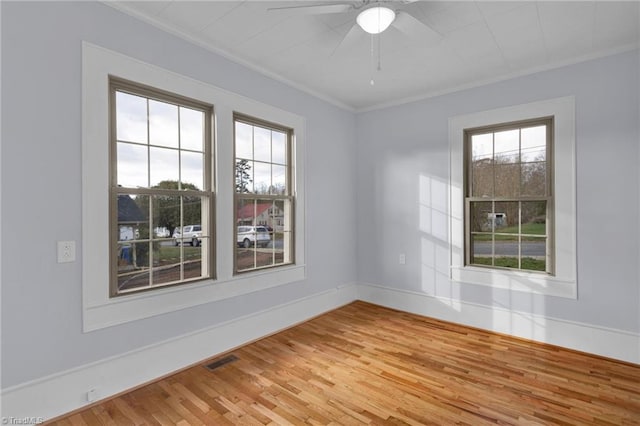 unfurnished room featuring wood-type flooring, ceiling fan, and ornamental molding