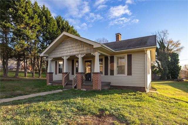 view of front of house with a porch and a front yard