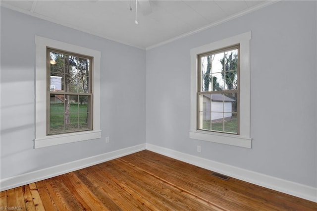 unfurnished room with wood-type flooring and ornamental molding