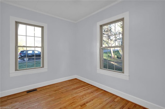 spare room with wood-type flooring and ornamental molding