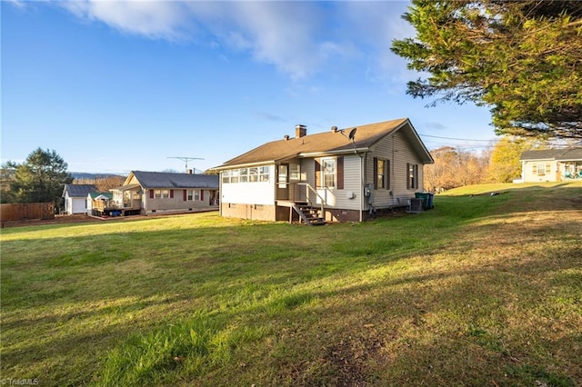 back of house with a lawn