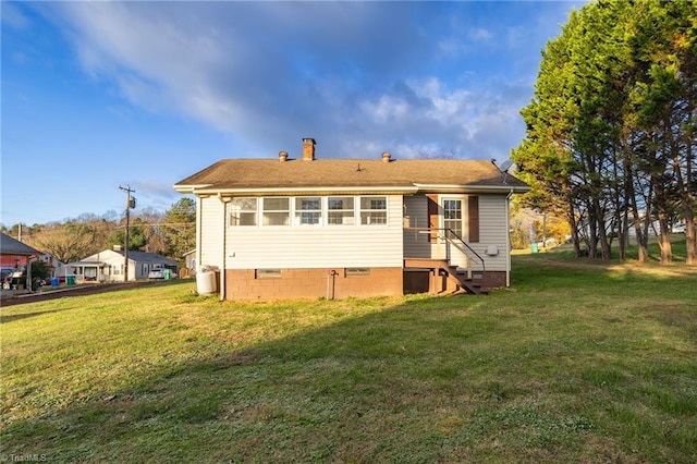 rear view of house with a yard