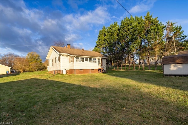 rear view of house featuring a lawn