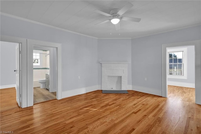 unfurnished living room featuring a fireplace, light wood-type flooring, ceiling fan, and ornamental molding