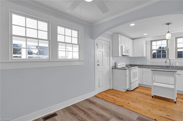 kitchen featuring light wood-type flooring, ornamental molding, white appliances, white cabinets, and hanging light fixtures