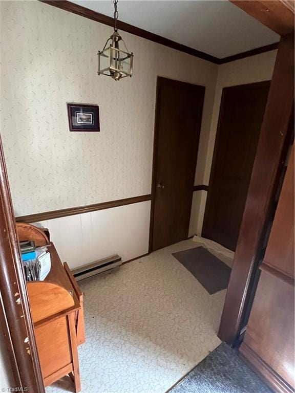 hallway with carpet, ornamental molding, wainscoting, and wallpapered walls