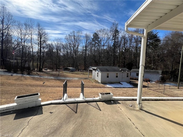 view of yard with an outdoor structure and fence