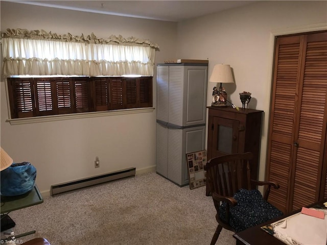 interior space with a baseboard heating unit and carpet floors