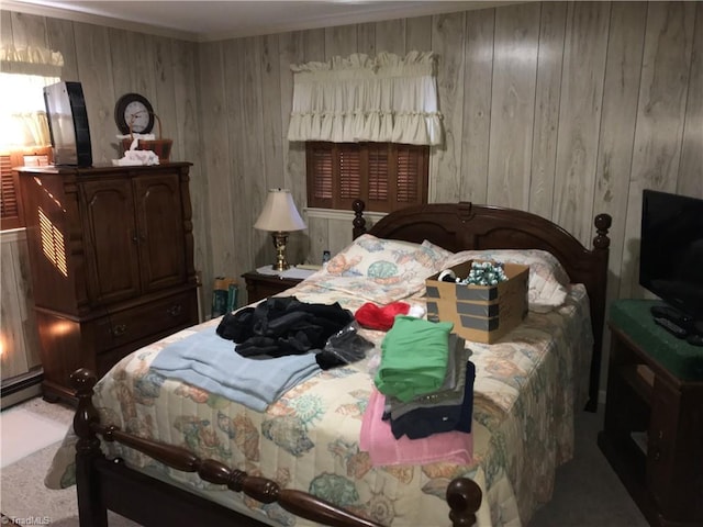 bedroom featuring a baseboard radiator and wooden walls