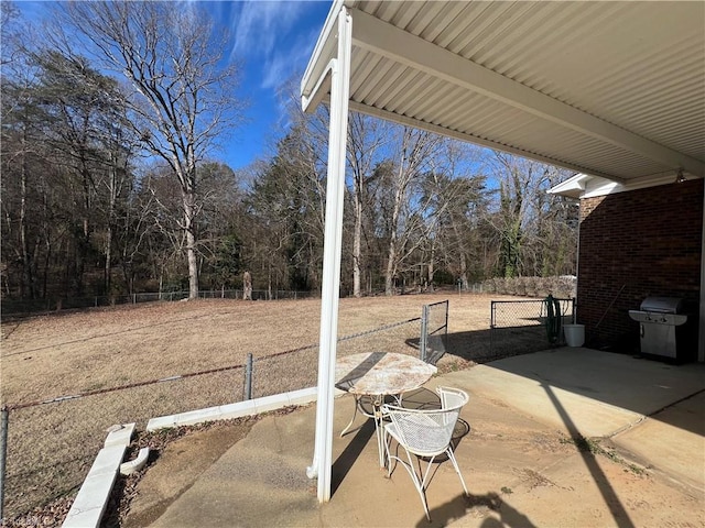 view of patio with fence and area for grilling