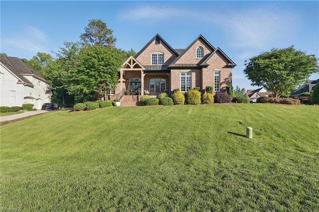 6204 Calendula Ct, Summerfield, NC 27358 - french country style house featuring a front lawn and brick siding