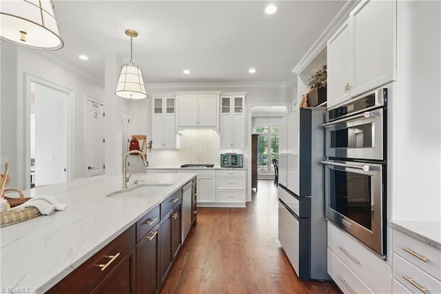 6204 Calendula Ct, Summerfield, NC 27358 - kitchen with appliances with stainless steel finishes, a sink, ornamental molding, white cabinets, and glass insert cabinets