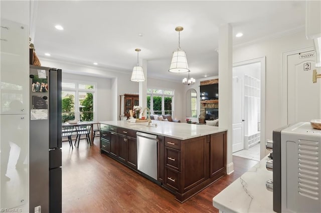 6204 Calendula Ct, Summerfield, NC 27358 - kitchen with stainless steel appliances, a sink, crown molding, dark wood-style flooring, and dark brown cabinets