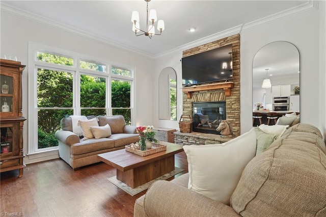 6204 Calendula Ct, Summerfield, NC 27358 - living room featuring crown molding, wood finished floors, a stone fireplace, a chandelier, and recessed lighting