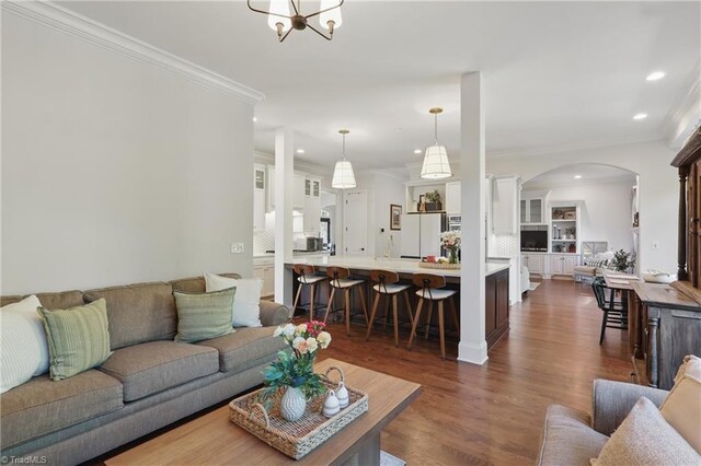 6204 Calendula Ct, Summerfield, NC 27358 - living room with recessed lighting, arched walkways, dark wood-style flooring, crown molding, and a chandelier