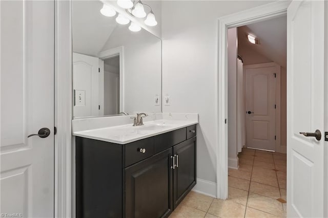 6204 Calendula Ct, Summerfield, NC 27358 - bathroom with vaulted ceiling, vanity, tile patterned floors, and baseboards