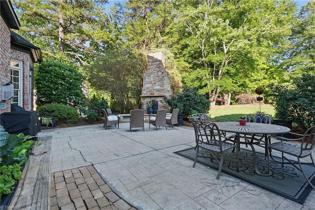6204 Calendula Ct, Summerfield, NC 27358 - view of patio / terrace with an outdoor stone fireplace and outdoor dining area