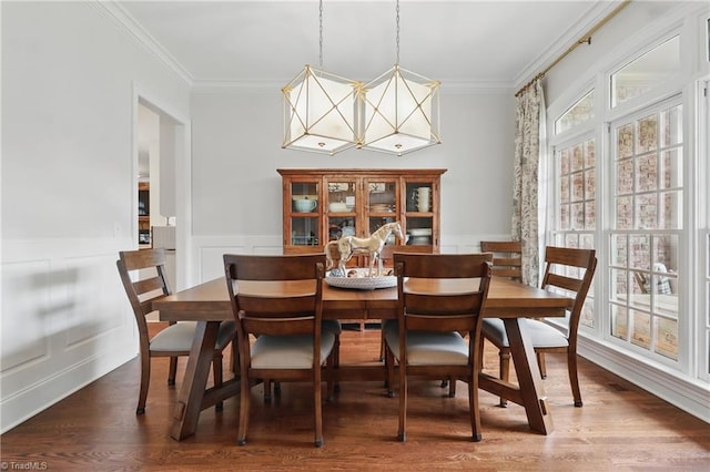 6204 Calendula Ct, Summerfield, NC 27358 - dining area with ornamental molding, a chandelier, wood finished floors, wainscoting, and a decorative wall