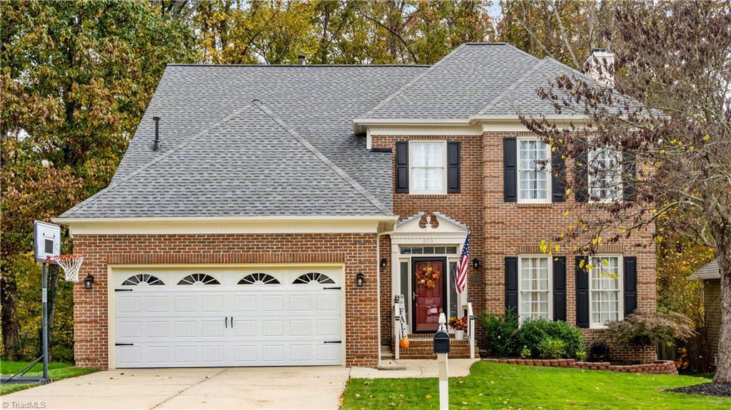 view of front of property with a garage and a front yard