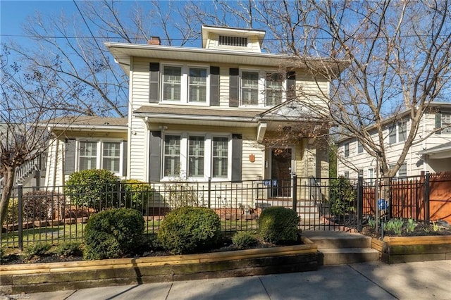 traditional style home with a fenced front yard