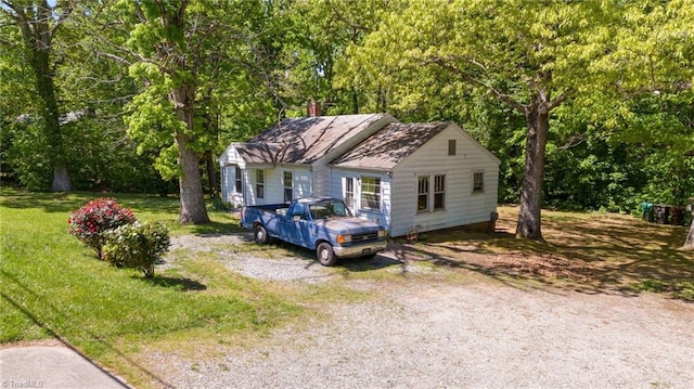 bungalow-style home with a front lawn