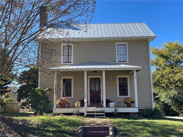 view of front of property with covered porch and a front lawn