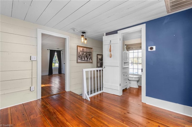 spare room with hardwood / wood-style floors, wood ceiling, and visible vents