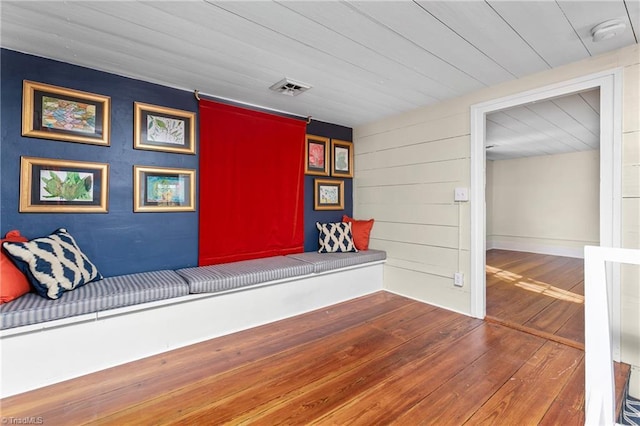 unfurnished room featuring wooden ceiling, visible vents, and wood-type flooring