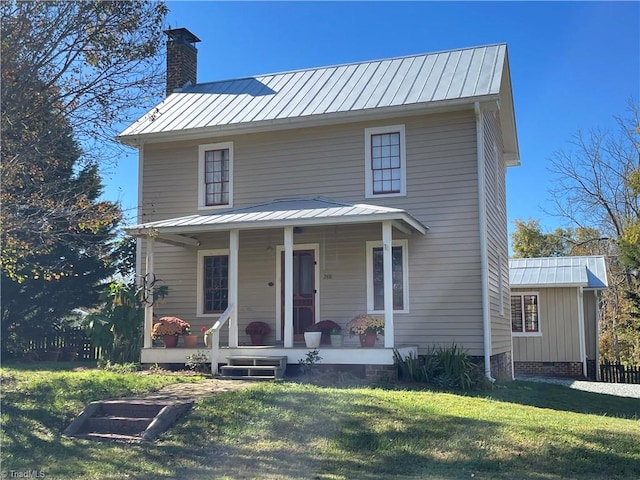 view of front facade with a front yard and covered porch