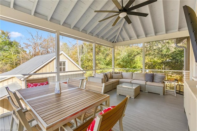 sunroom / solarium with plenty of natural light, vaulted ceiling with beams, and ceiling fan