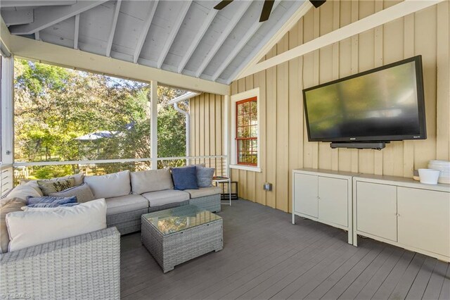 sunroom / solarium featuring a ceiling fan and vaulted ceiling with beams