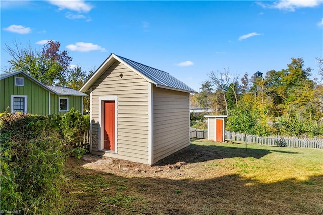 view of shed featuring fence