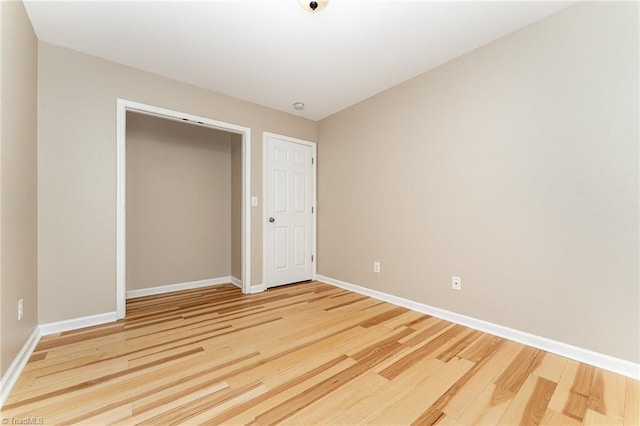 2305 Hartfield Cir, Winston-Salem, NC 27103 - unfurnished bedroom featuring light wood-type flooring, baseboards, and a closet