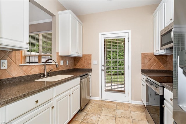 2305 Hartfield Cir, Winston-Salem, NC 27103 - kitchen featuring a sink, dark countertops, stainless steel appliances, white cabinetry, and backsplash