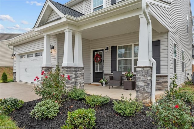 view of front of property featuring covered porch and a garage